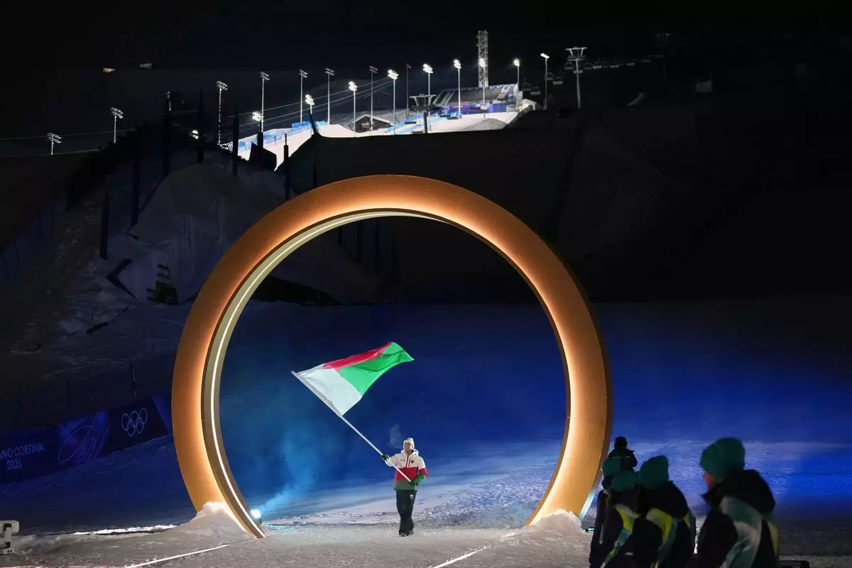 Mathieu Gravier, flag bearer of Madagascar, walks during the Olympic opening ceremony at the 2026 Winter Olympics, in Livigno, Italy, Friday, Feb. 6, 2026. (AP Photo/Abbie Parr)