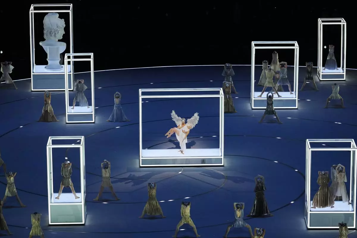 Performers take part in the Olympic opening ceremony at the 2026 Winter Olympics, in Milan, Italy, Friday, Feb. 6, 2026. (AP Photo/Ben Curtis)