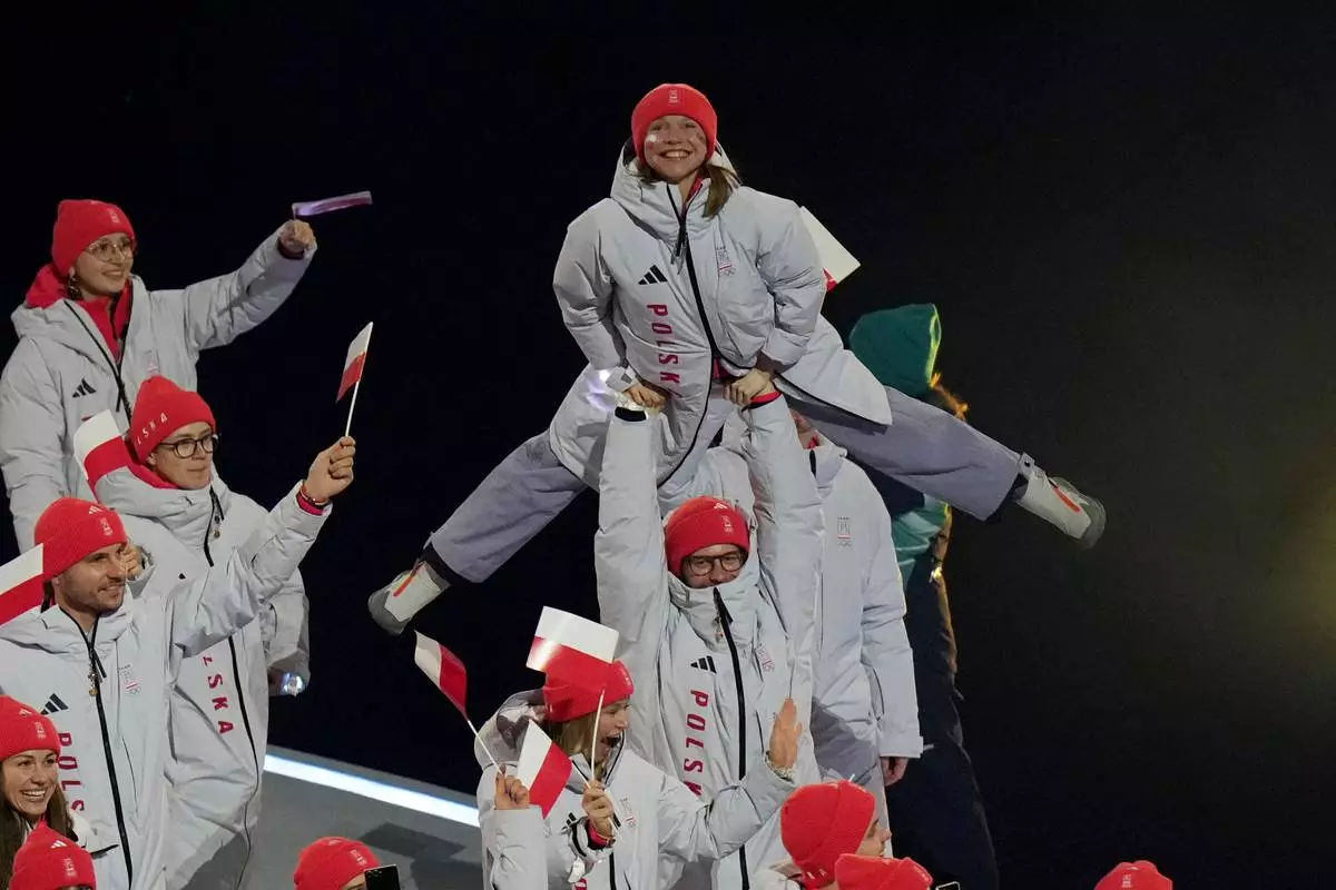 Athletes from Poland walk during the Olympic opening ceremony at the 2026 Winter Olympics, in Milan, Italy, Friday, Feb. 6, 2026. (AP Photo/Francisco Seco)