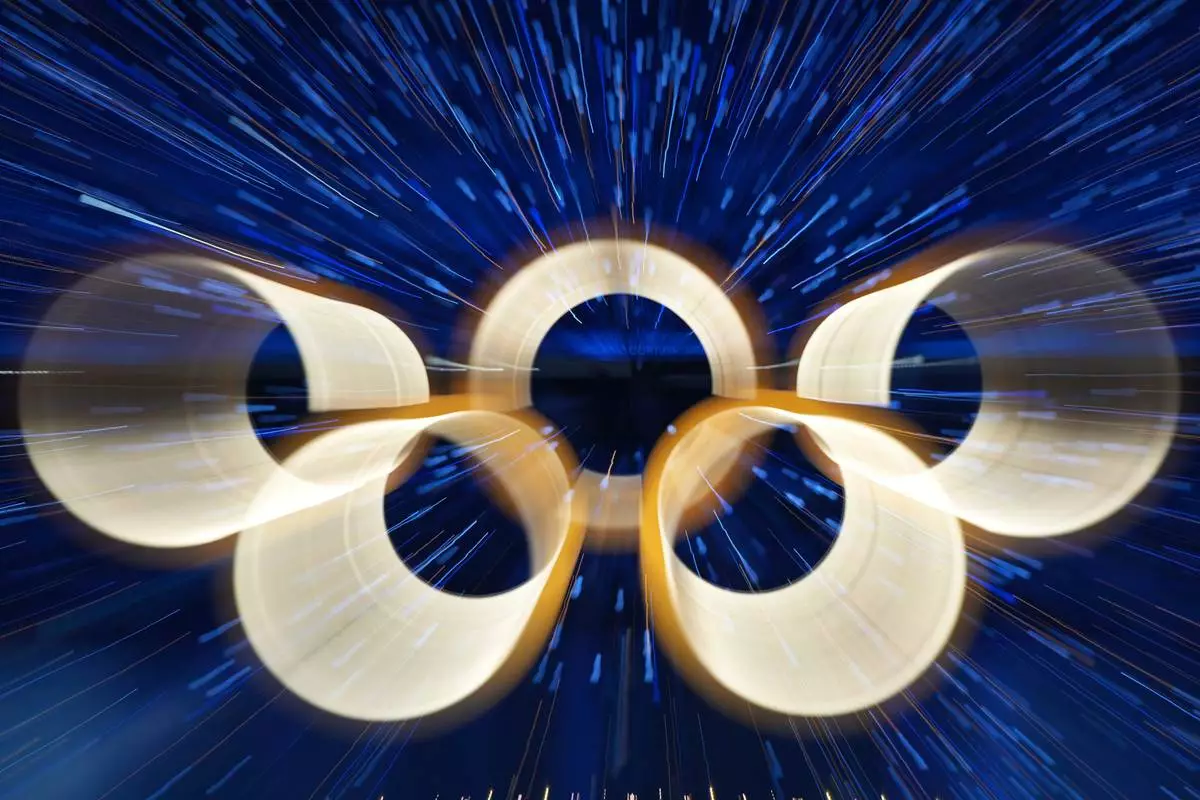 The Olympic rings are illuminated during the Olympic opening ceremony at the 2026 Winter Olympics, in Milan, Italy, Friday, Feb. 6, 2026. (AP Photo/Francisco Seco)