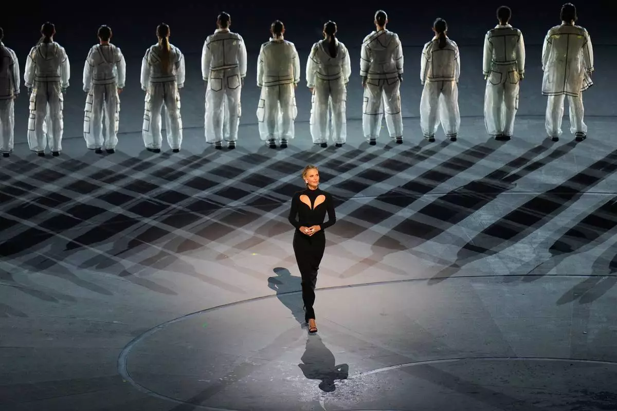 Actress Charlize Theron performs during the Olympic opening ceremony at the 2026 Winter Olympics, in Milan, Italy, Friday, Feb. 6, 2026. (AP Photo/Hassan Ammar)
