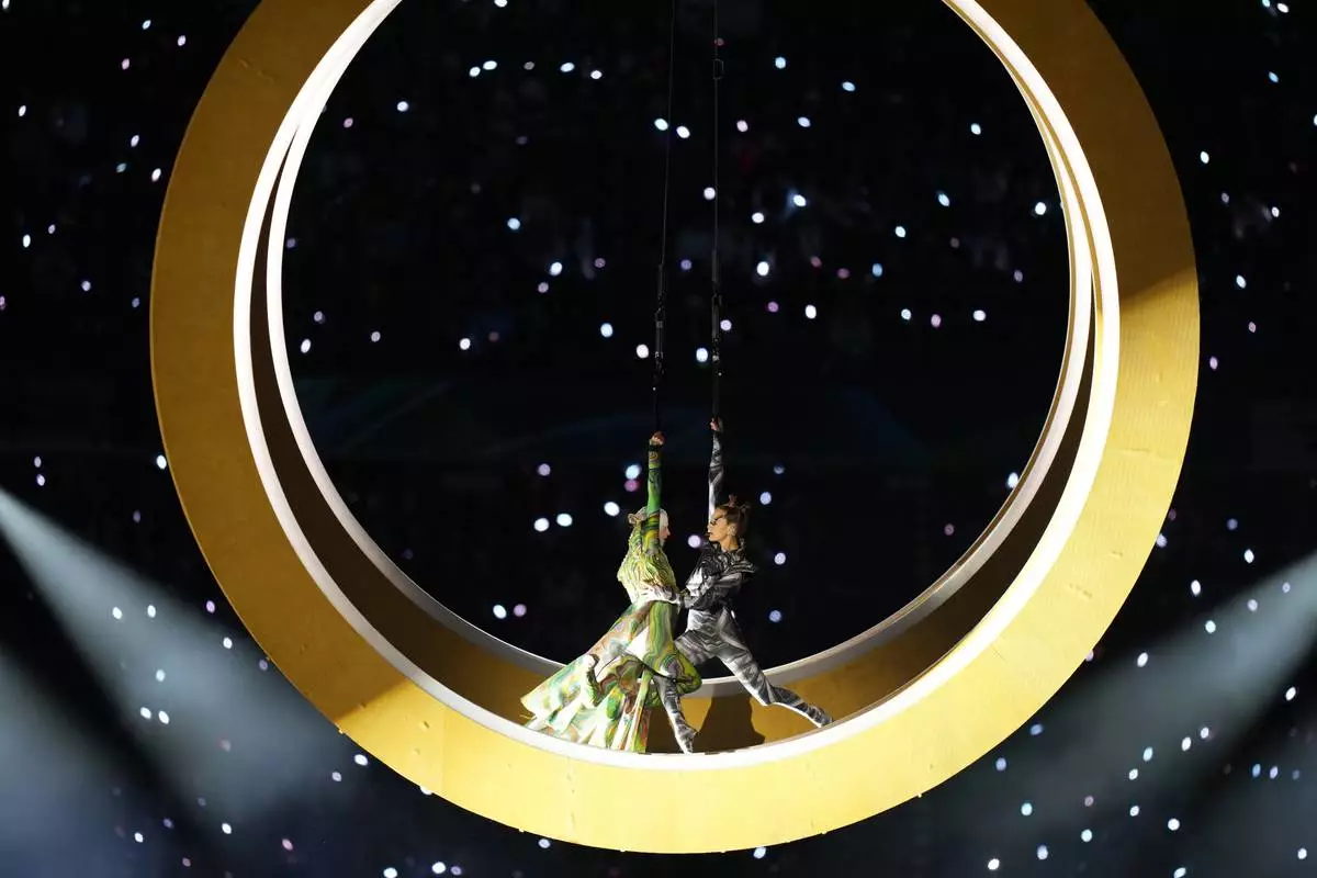 Artists perform during the Olympic opening ceremony at the 2026 Winter Olympics, in Milan, Italy, Friday, Feb. 6, 2026. (AP Photo/Stephanie Scarbrough)