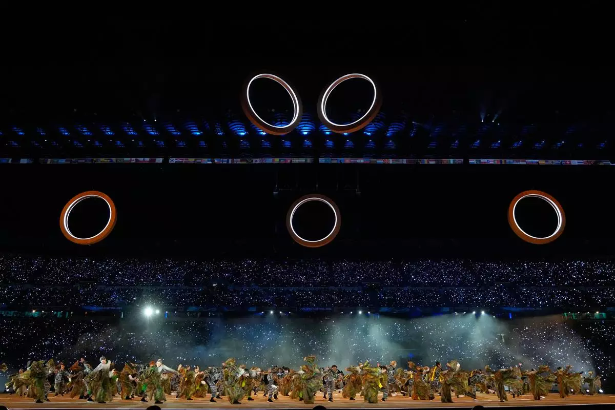The Olympic rings begin to form during a performance at the Olympic opening ceremony at the 2026 Winter Olympics, in Milan, Italy, Friday, Feb. 6, 2026. (AP Photo/Natacha Pisarenko)