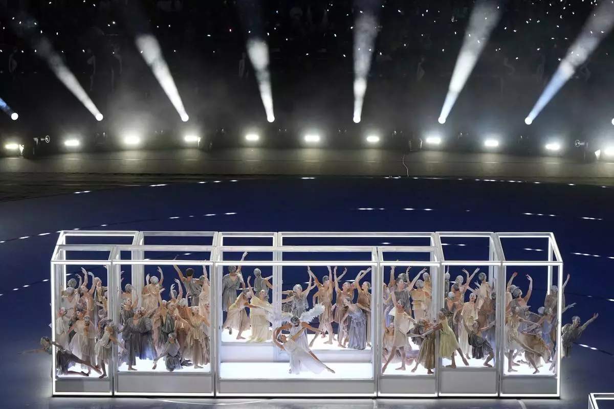 Dancers perform during the Olympic opening ceremony at the 2026 Winter Olympics, in Milan, Italy, Friday, Feb. 6, 2026. (AP Photo/Francisco Seco)