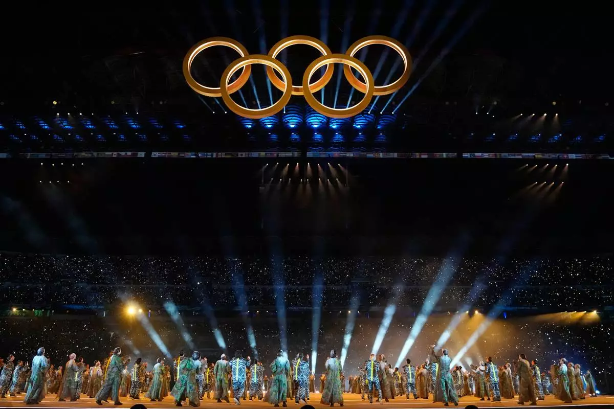 The Olympic rings are formed during a performance at the Olympic opening ceremony at the 2026 Winter Olympics, in Milan, Italy, Friday, Feb. 6, 2026. (AP Photo/Natacha Pisarenko)