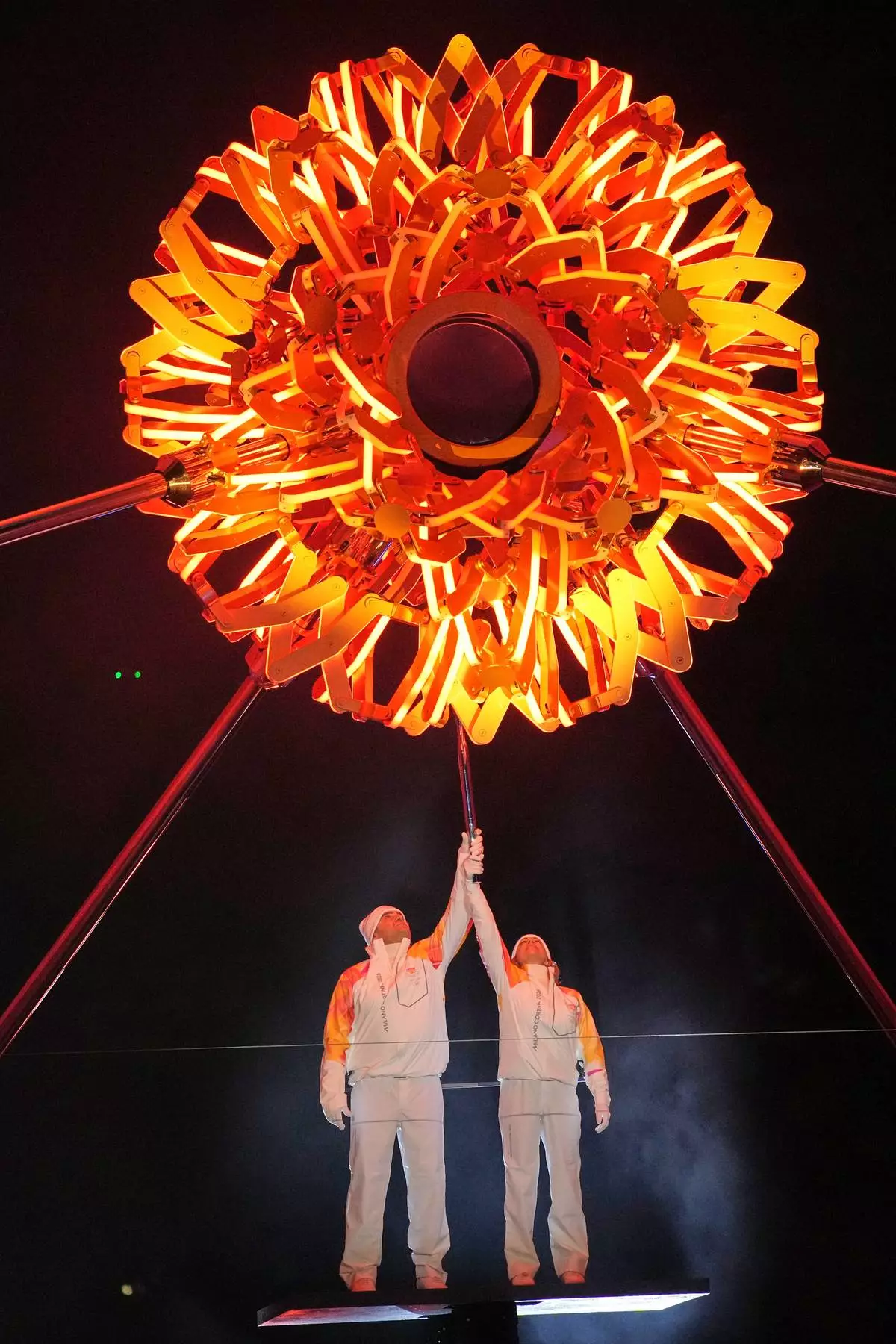 Italian former skier Deborah Compagnoni and Italian former skier Alberto Tomba light the cauldron at the Arco della Pace during the Olympic opening ceremony at the 2026 Winter Olympics, in Milan, Italy, Friday, Feb. 6, 2026. (AP Photo/Christophe Ena)