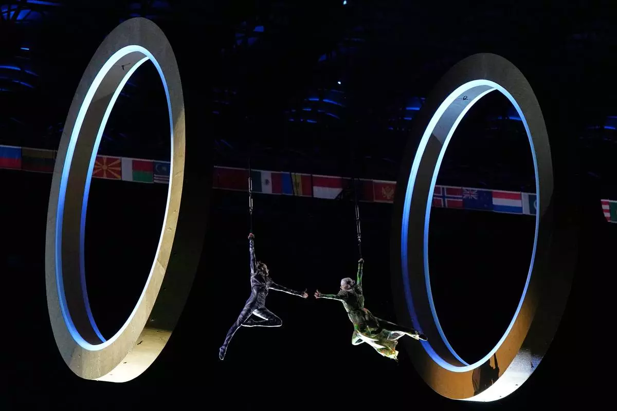Dancers perform during the Olympic opening ceremony at the 2026 Winter Olympics, in Milan, Italy, Friday, Feb. 6, 2026. (AP Photo/Ashley Landis)
