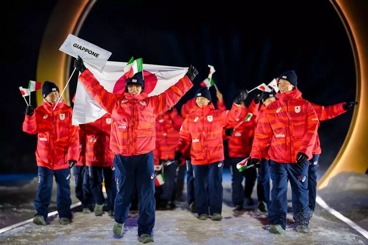 Japan athletes take part in the athletes parade during the Olympic opening ceremony at the 2026 Winter Olympics, in Predazzo, Italy, Friday, Feb. 6, 2026. (AP Photo/Matthias Schrader)