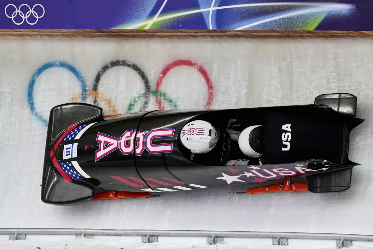 United States' Frankie del Duca, left, slides down the track during a two man bobsled training session at the 2026 Winter Olympics, in Cortina d'Ampezzo, Italy, Saturday, Feb. 14, 2026. (AP Photo/Aijaz Rahi)