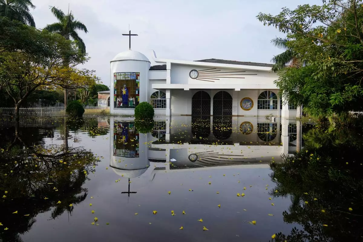 The Maria de los Angeles Church is flooded after the Sinu River overflowed in Monteria, Colombia, Tuesday, Feb. 10, 2026. (AP Photo/Fernando Vergara)