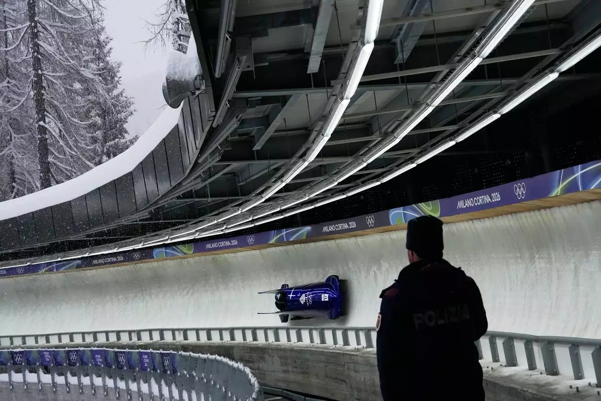 Great Britain's Adele Nicoll, right, slides down the track during a two women bobsled training session at the 2026 Winter Olympics, in Cortina d'Ampezzo, Italy, Thursday, Feb. 19, 2026. (AP Photo/Alessandra Tarantino)