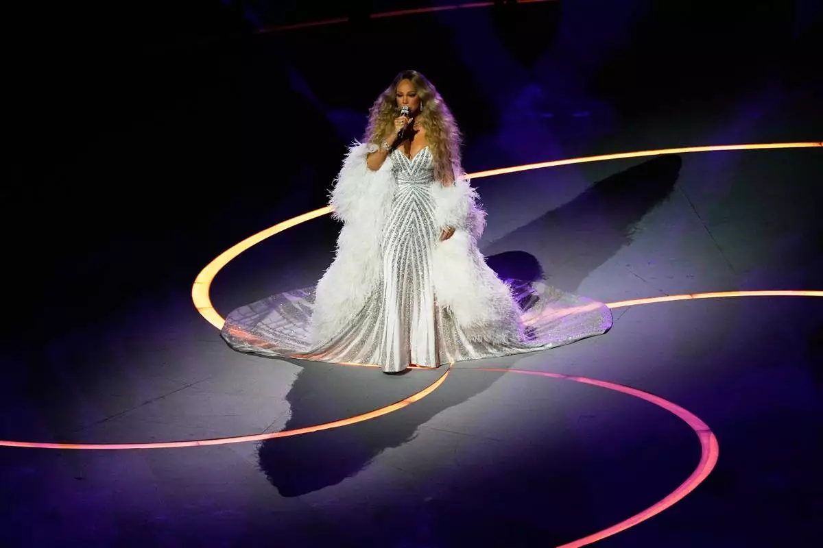 Singer Mariah Carey performs during the Olympic opening ceremony at the 2026 Winter Olympics, in Milan, Italy, Friday, Feb. 6, 2026. (AP Photo/Petr David Josek)
