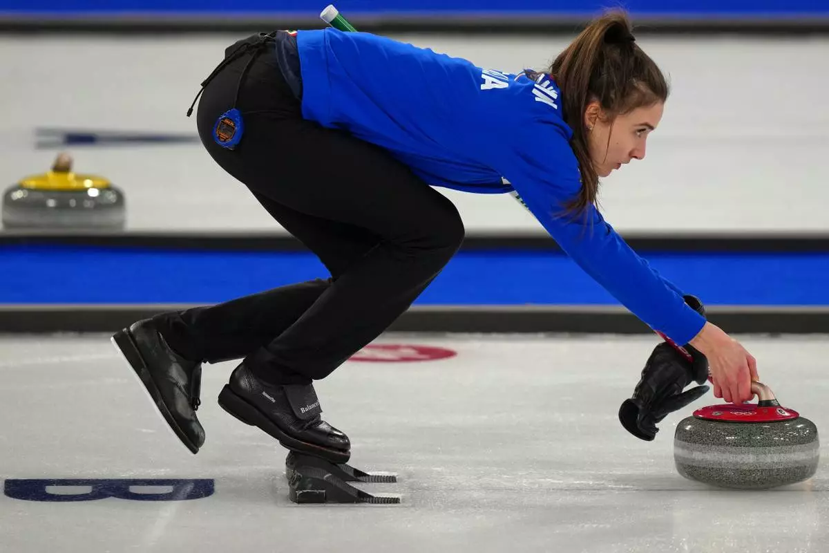 Italy's Stefania Constantini in action during the mixed doubles round robin phase of the curling competition against Estonia, at the 2026 Winter Olympics, in Cortina d'Ampezzo, Italy, Friday, Feb. 6, 2026. (AP Photo/Misper Apawu)