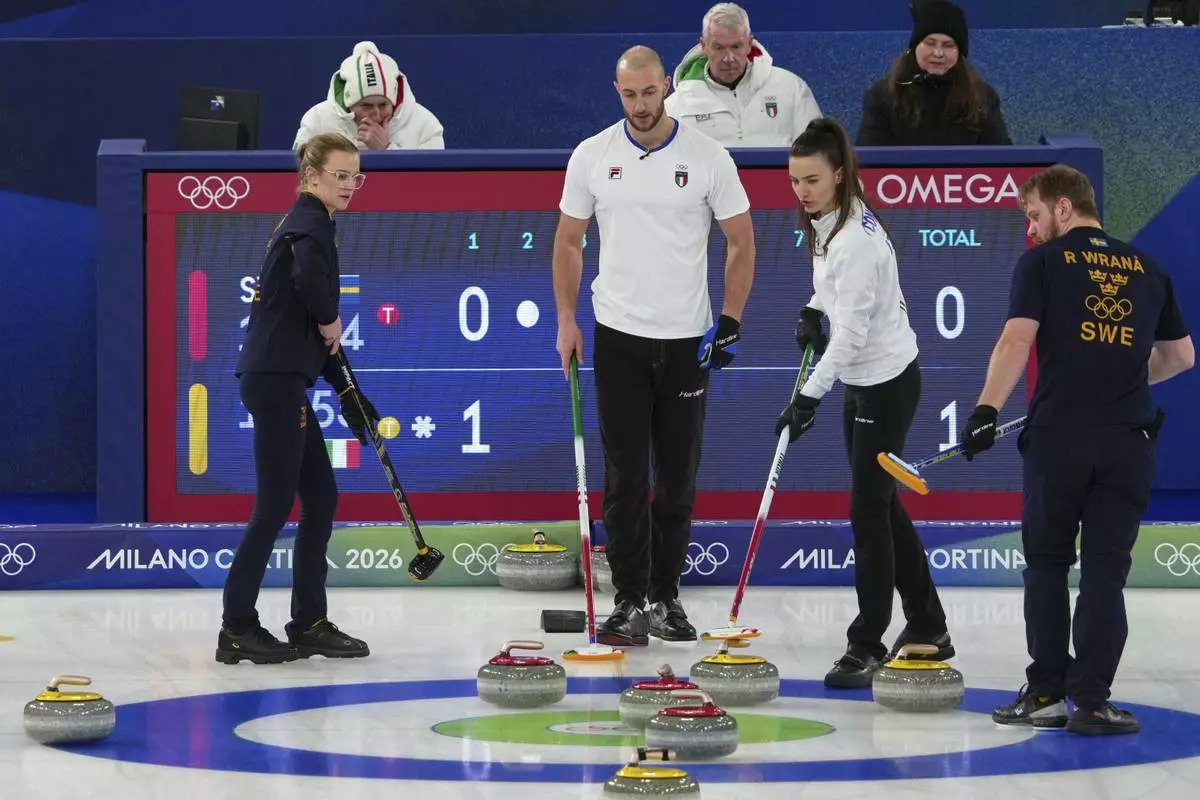 Italy's Amos Mosaner and Stefania Constantini and Sweden's Isabella Wranaa and Rasmus Wranaa compete during the mixed doubles round robin phase of the curling competition, at the 2026 Winter Olympics, in Cortina d'Ampezzo, Italy, Saturday, Feb. 7, 2026. (AP Photo/Misper Apawu)