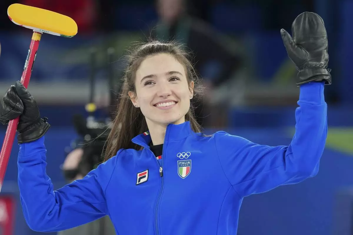 Italy's Stefania Constantini celebrates their win during the mixed doubles round robin phase of the curling competition against Estonia, at the 2026 Winter Olympics, in Cortina d'Ampezzo, Italy, Friday, Feb. 6, 2026. (AP Photo/Misper Apawu)