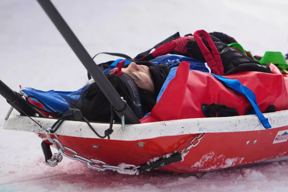 China's Liu Jiayu is stretchered off after crashing during the women's snowboarding halfpipe qualifications at the 2026 Winter Olympics, in Livigno, Italy, Wednesday, Feb. 11, 2026. (AP Photo/Lindsey Wasson)