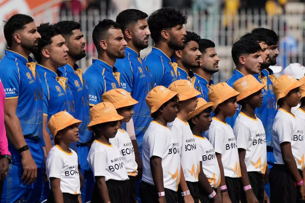United Arab Emirates's players stand up for the national anthems before the start of the during the T20 World Cup cricket match between New Zealand and United Arab Emirates in Chennai, India, Tuesday, Feb. 10, 2026. (AP Photo/Mahesh Kumar A.)