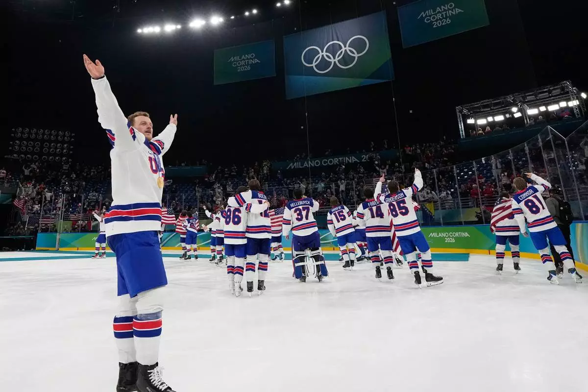 United States' Jack Eichel celebrates with teammates after defeating Canada in a men's ice hockey gold medal game between Canada and the United States at the 2026 Winter Olympics, in Milan, Italy, Sunday, Feb. 22, 2026. (AP Photo/Petr David Josek)