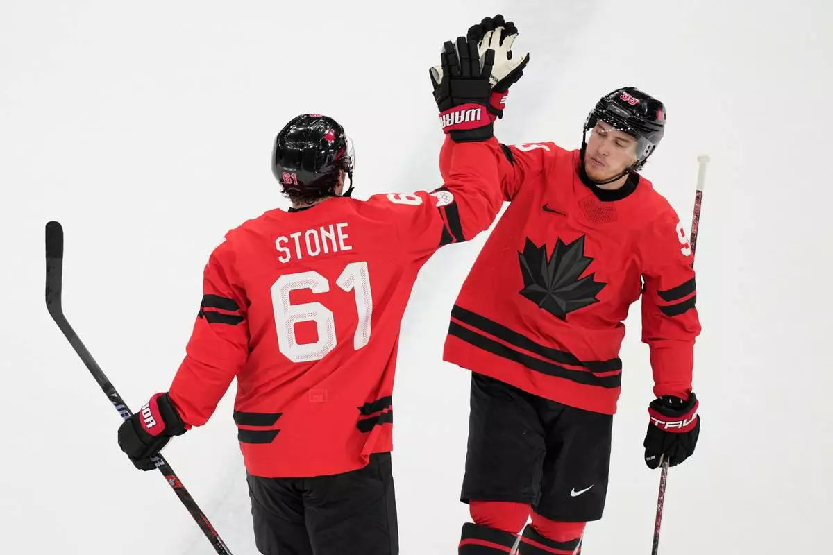 Canada's Mark Stone (61) celebrates after scoring a goal during a preliminary round game of men's ice hockey between Canada and France at the 2026 Winter Olympics, in Milan, Italy, Sunday, Feb. 15, 2026. (AP Photo/Hassan Ammar)
