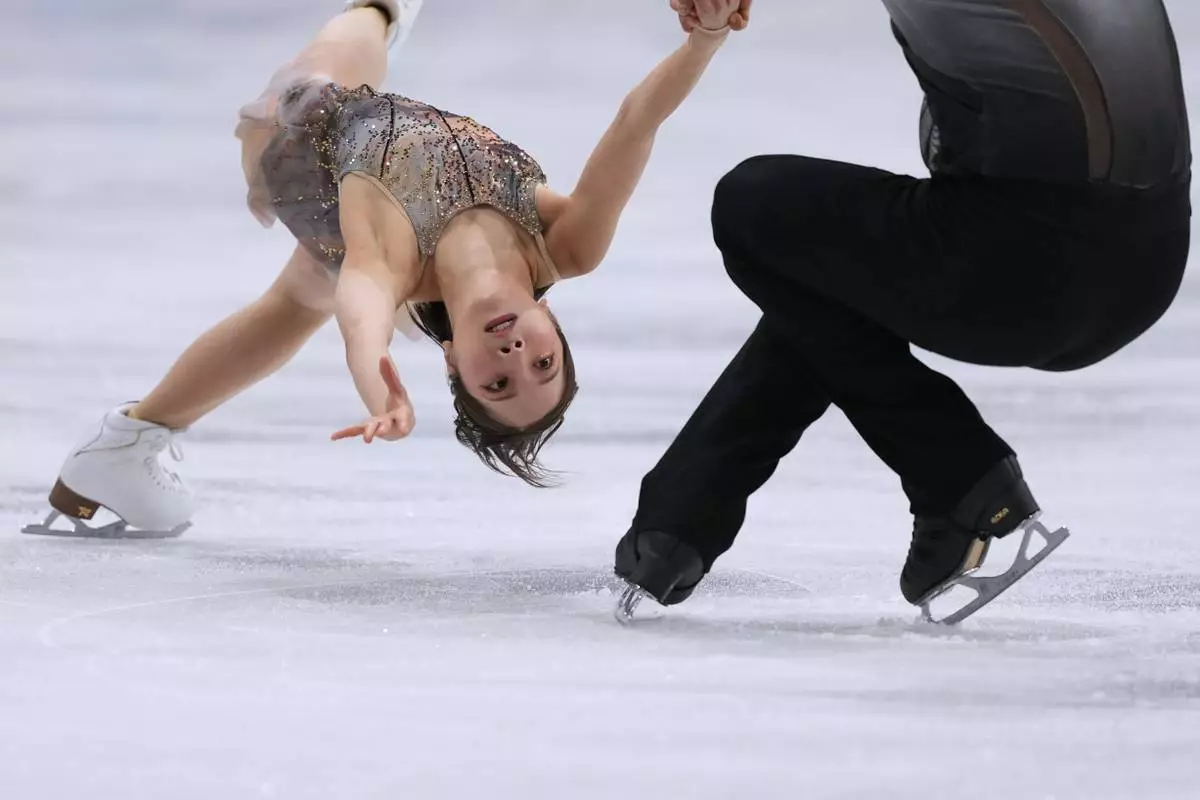 Riku Miura and Ryuichi Kihara of Japan compete during the figure skating pairs team event at the 2026 Winter Olympics, in Milan, Italy, Sunday, Feb. 8, 2026. (AP Photo/Stephanie Scarbrough)
