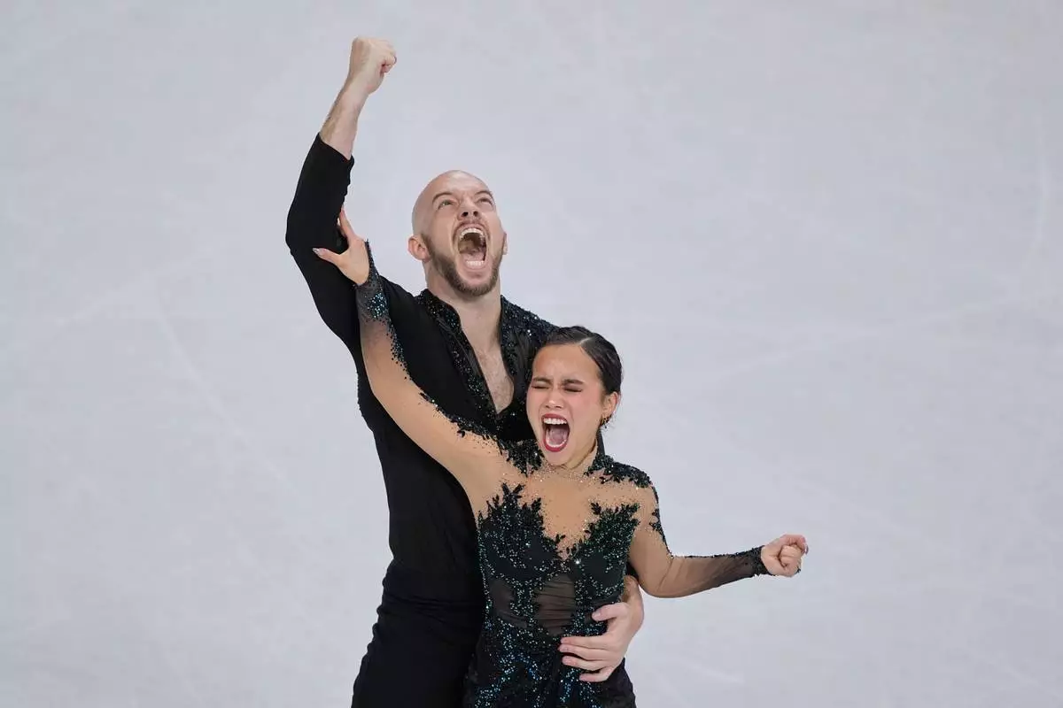 Ellie Kam and Danny O'Shea of the United States compete during the figure skating pairs team event at the 2026 Winter Olympics, in Milan, Italy, Sunday, Feb. 8, 2026. (AP Photo/Natacha Pisarenko)