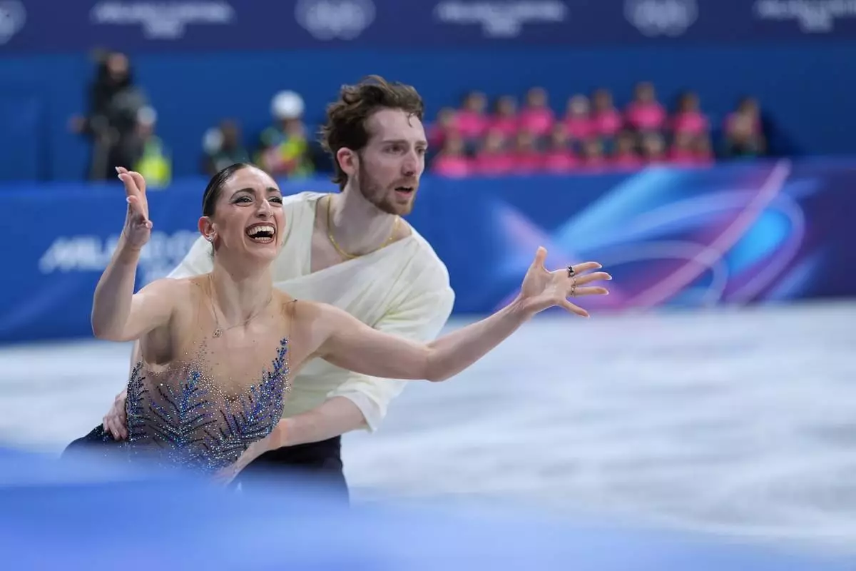 Sara Conti and Niccolo Macii of Italy compete during the figure skating pairs team event at the 2026 Winter Olympics, in Milan, Italy, Sunday, Feb. 8, 2026. (AP Photo/Stephanie Scarbrough)