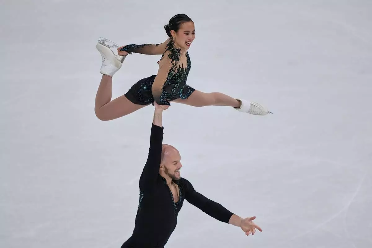 Ellie Kam and Danny O'Shea of the United States compete during the figure skating pairs team event at the 2026 Winter Olympics, in Milan, Italy, Sunday, Feb. 8, 2026. (AP Photo/Natacha Pisarenko)