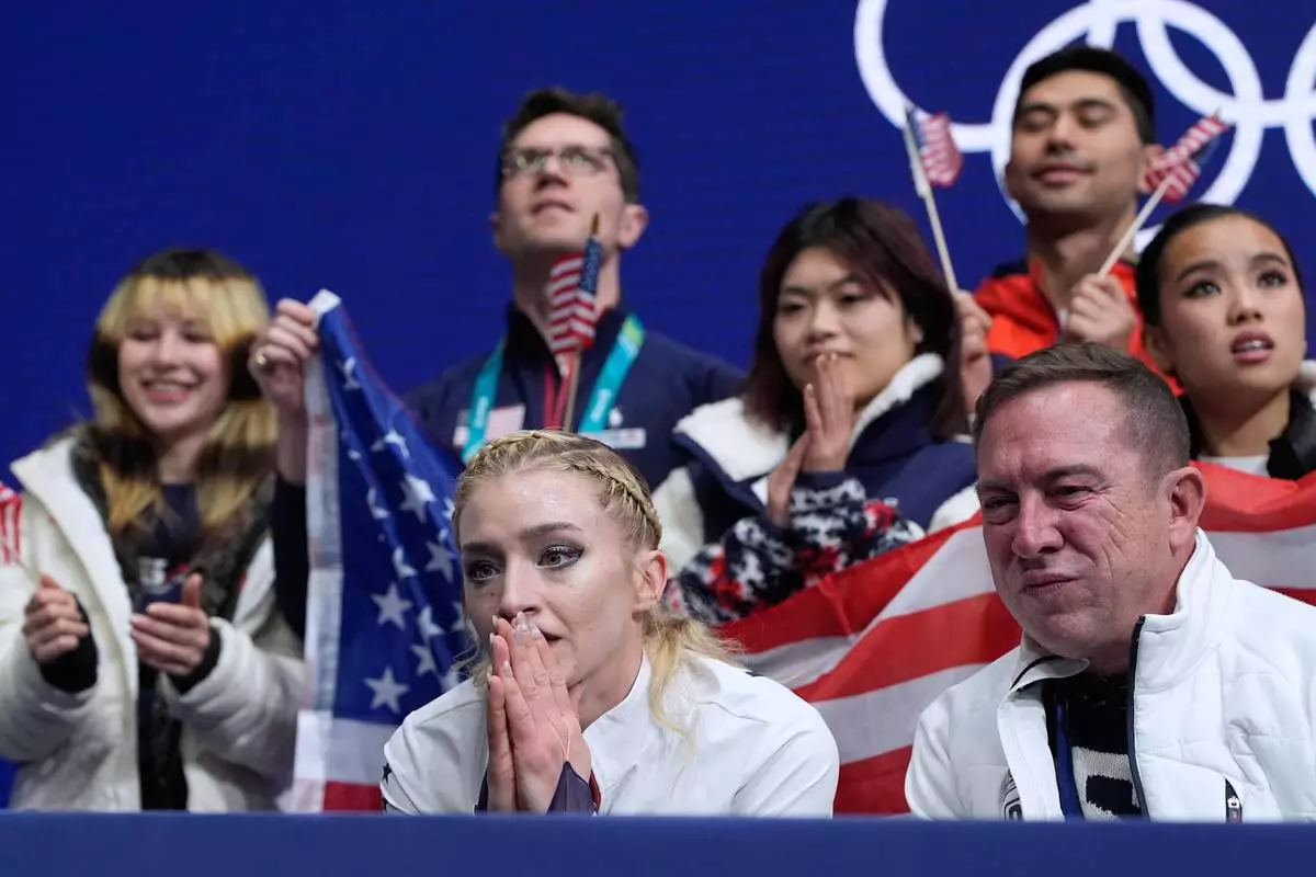 Amber Glenn of the United States reacts to her scores after competing during the figure skating women's team event at the 2026 Winter Olympics, in Milan, Italy, Sunday, Feb. 8, 2026. (AP Photo/Ashley Landis)
