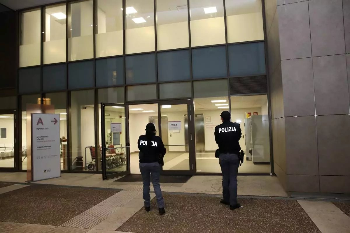 Police officers stand at the doors of a buildin in Ca' Foncello Hospital in Treviso, Italy, Sunday, Feb. 8, 2026, where U.S. skier Lindsey Vonn is hospitalized with a broken leg after crashing during the women's downhill competition at the Milan-Cortina Olympics. (Paola Garbuio/LaPresse via AP)