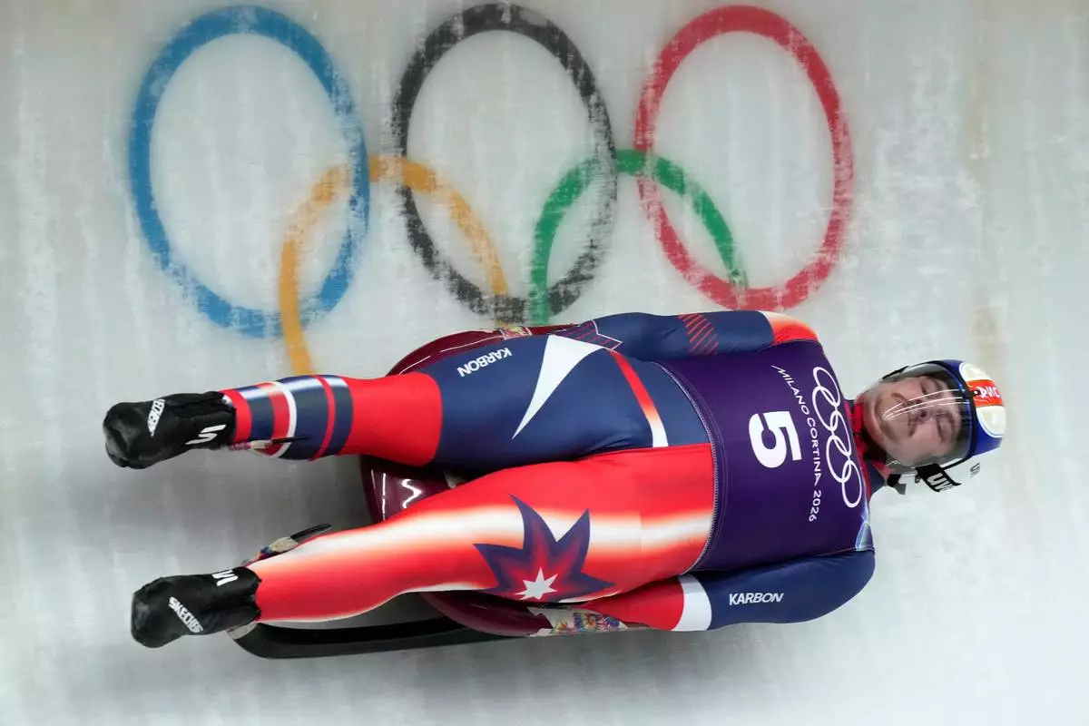 USA's Matthew Greiner slides down the track during a men's Luge training session at the 2026 Winter Olympics, in Cortina d'Ampezzo, Italy, Thursday, Feb. 5, 2026. (AP Photo/Aijaz Rahi)