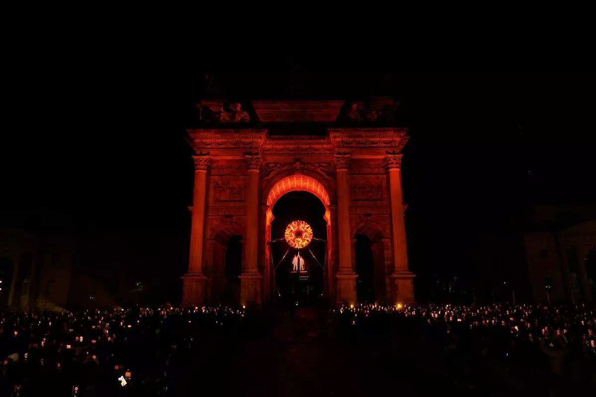 Italian former skier Deborah Compagnoni and Italian former skier Alberto Tomba light the cauldron at the Arco della Pace during the Olympic opening ceremony at the 2026 Winter Olympics, in Milan, Italy, Friday, Feb. 6, 2026. (AP Photo/Loaner12)