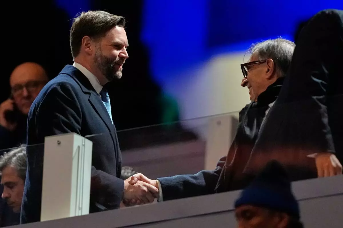 Vice President JD Vance greets people as he arrives for the Olympic opening ceremony at the 2026 Winter Olympics, in Milan, Italy, Friday, Feb. 6, 2026. (AP Photo/Ashley Landis)