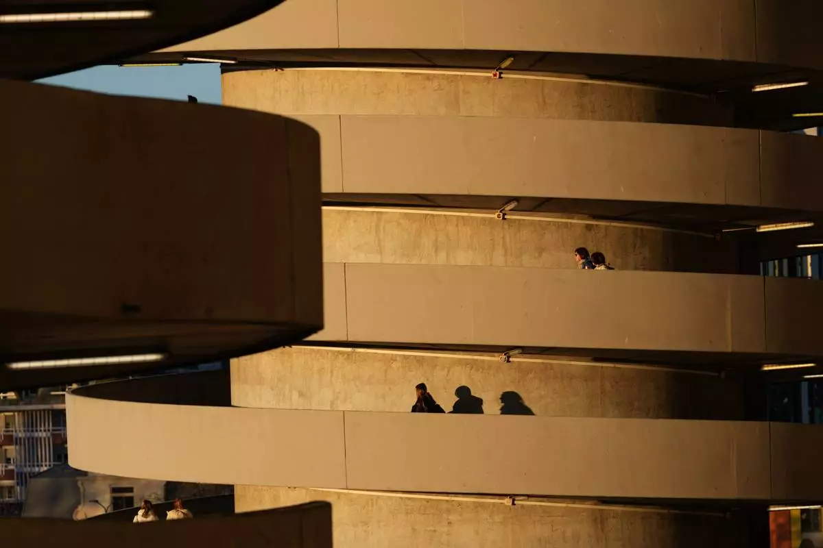 Spectators arrive for the Olympic opening ceremony at the 2026 Winter Olympics, in Milan, Italy, Friday, Feb. 6, 2026. (AP Photo/Ben Curtis)