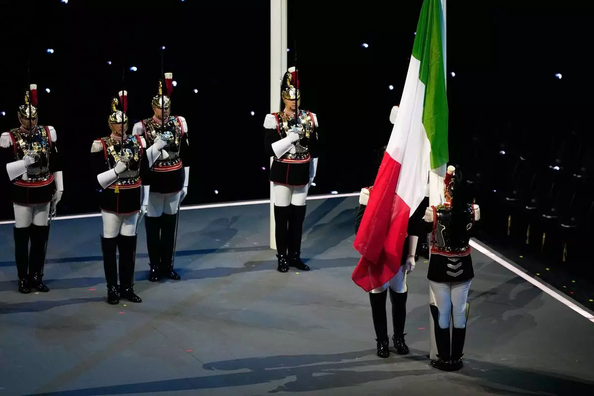 The Italian flag was raised during the Olympic opening ceremony at the 2026 Winter Olympics, in Milan, Italy, Friday, Feb. 6, 2026. (AP Photo/Petr David Josek)
