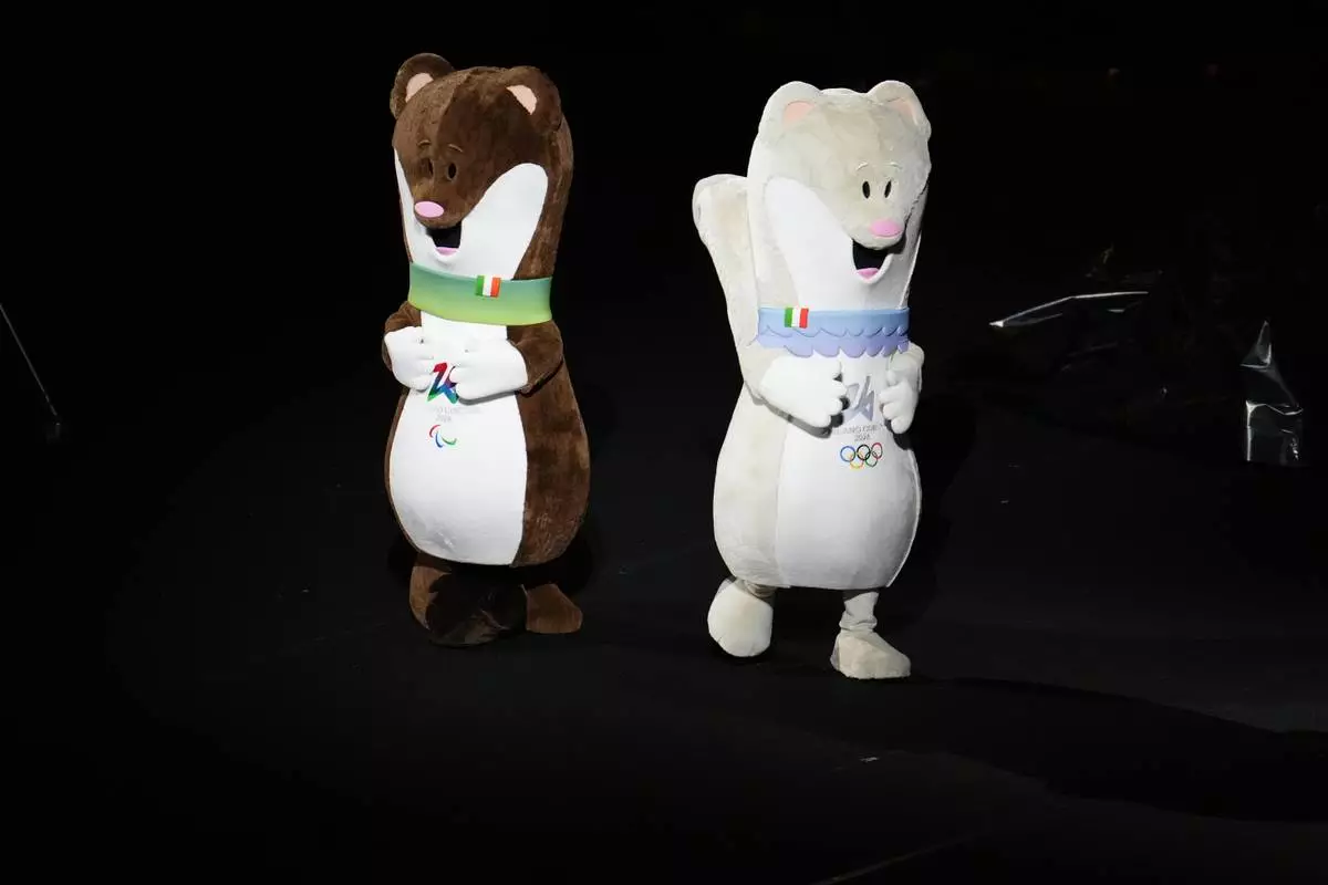 Tina and Milo, Olympics and Paralympics mascots, dance before the Olympic opening ceremony at the 2026 Winter Olympics, in Milan, Italy, Friday, Feb. 6, 2026. (AP Photo/Ben Curtis)