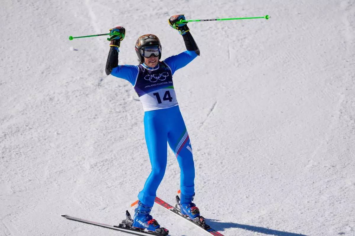 Italy's Federica Brignone celebrates at the finish area of an alpine ski, women's giant slalom race, at the 2026 Winter Olympics, in Cortina d'Ampezzo, Italy, Sunday, Feb. 15, 2026. (AP Photo/Andy Wong)