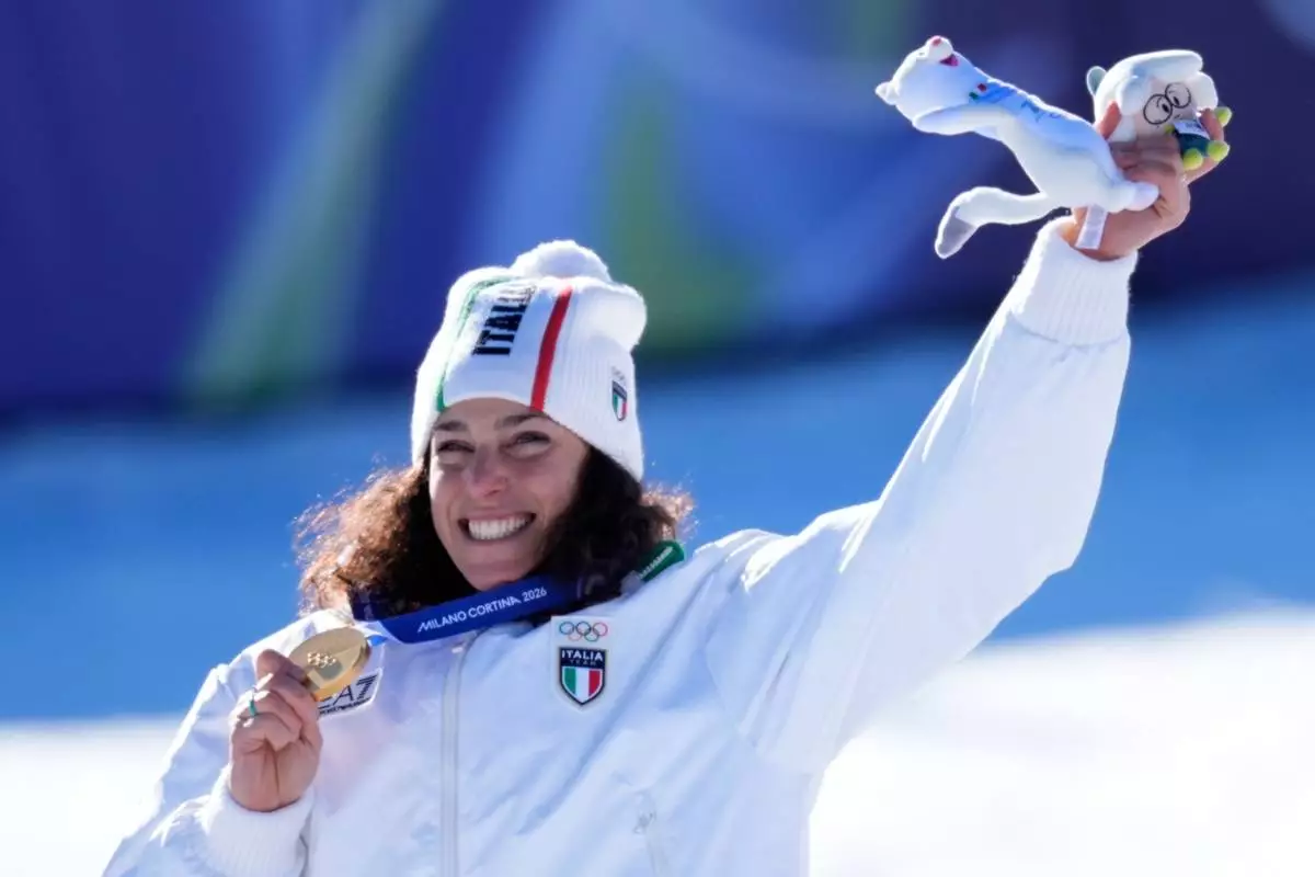 Italy's Federica Brignone shows the gold medal of an alpine ski, women's giant slalom race, at the 2026 Winter Olympics, in Cortina d'Ampezzo, Italy, Sunday, Feb. 15, 2026. (AP Photo/Robert F. Bukaty)