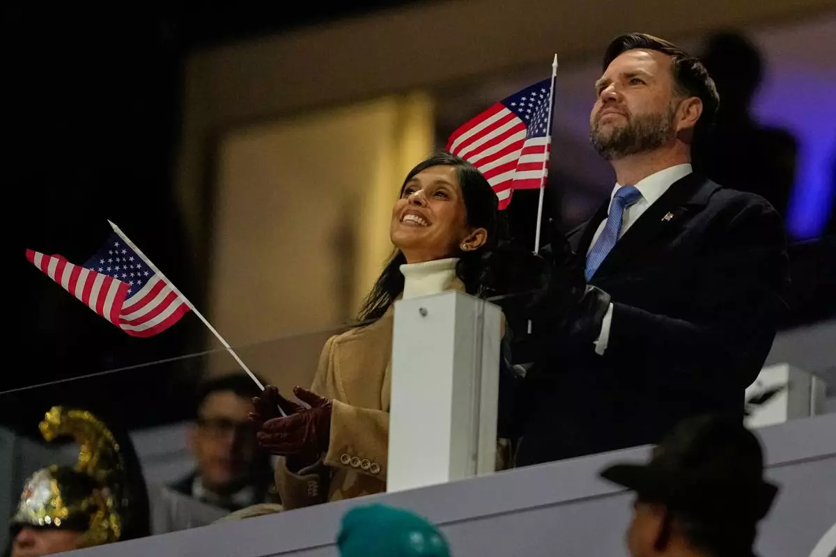 Vice President JD Vance and his wife Usha Vance cheer on team USA during the Olympic opening ceremony at the 2026 Winter Olympics, in Milan, Italy, Friday, Feb. 6, 2026. (AP Photo/Ashley Landis)