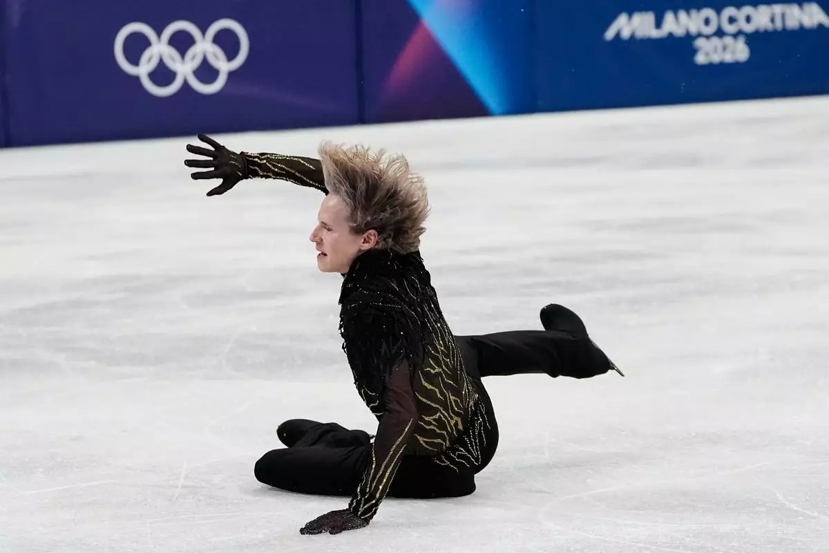 Ilia Malinin of the United States falls during the men's free skate program in figure skating at the 2026 Winter Olympics, in Milan, Italy, Friday, Feb. 13, 2026. (AP Photo/Natacha Pisarenko)