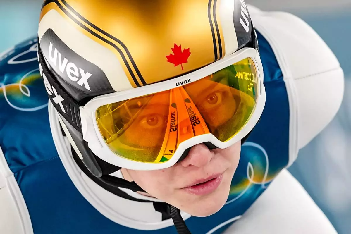 Nicole Maurer, of Canada, goes down the ramp during her trial jump of the ski jumping women's normal hill individual, at the 2026 Winter Olympics, in Predazzo, Italy, Saturday, Feb. 7, 2026. (AP Photo/Matthias Schrader)