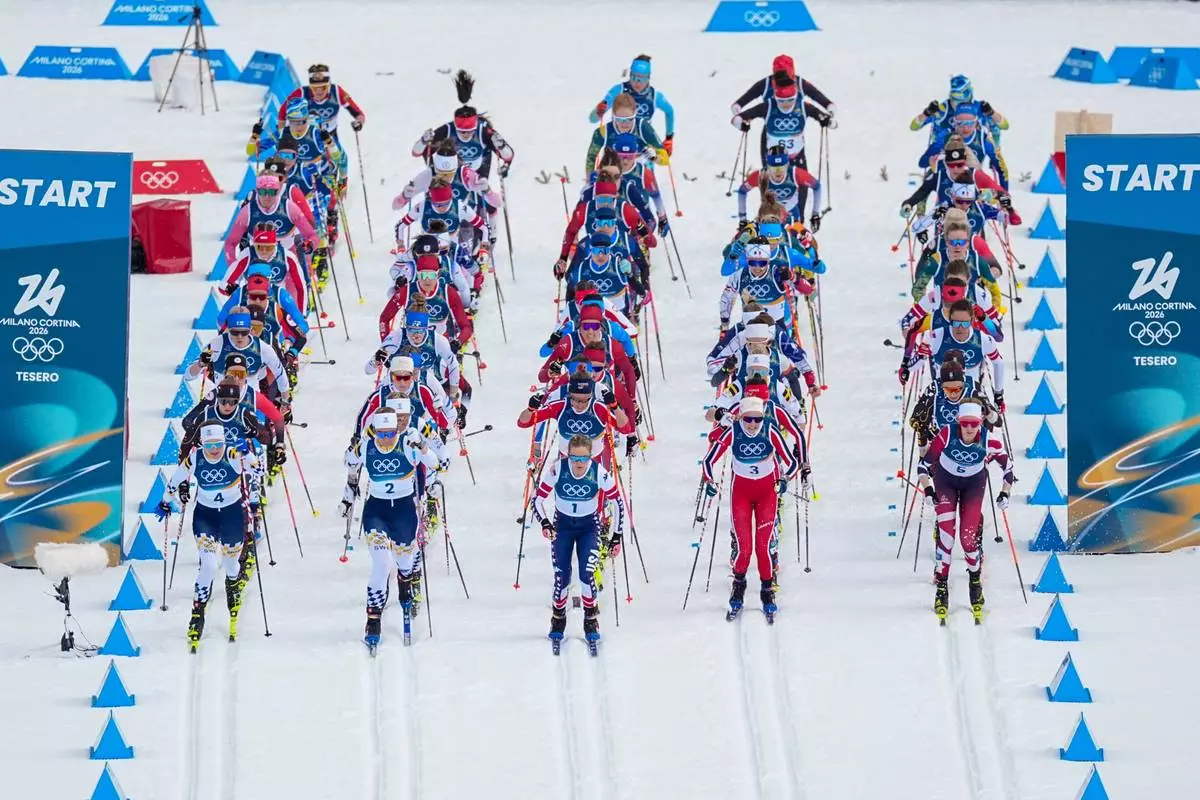 Jessie Diggins of the United States, center, and others start in the cross country skiing women's 10km + 10km skiathlon at the 2026 Winter Olympics, in Tesero, Italy, Saturday, Feb. 7, 2026. (AP Photo/Matthias Schrader)