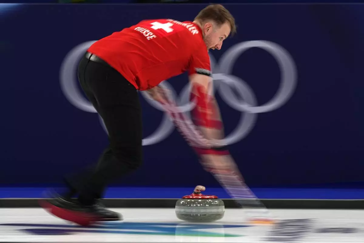 Switzerland's Yannick Schwaller in action during the mixed doubles round robin phase of the curling competition against Sweden at the 2026 Winter Olympics, in Cortina d'Ampezzo, Italy, Saturday, Feb. 7, 2026. (AP Photo/Fatima Shbair)