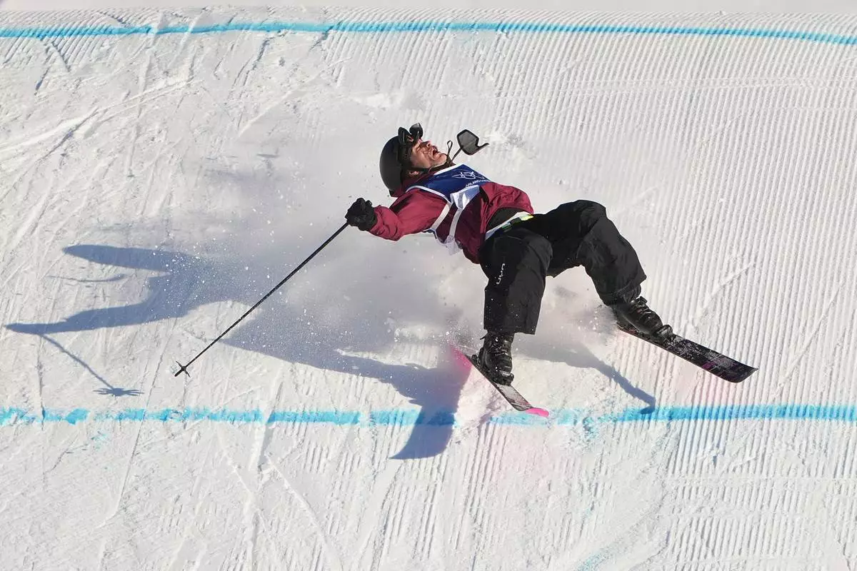 Austria's Julius Forer crashes during men's freestyle skiing slopestyle qualifications at the 2026 Winter Olympics, in Livigno, Italy, Saturday, Feb. 7, 2026. (AP Photo/Lindsey Wasson)