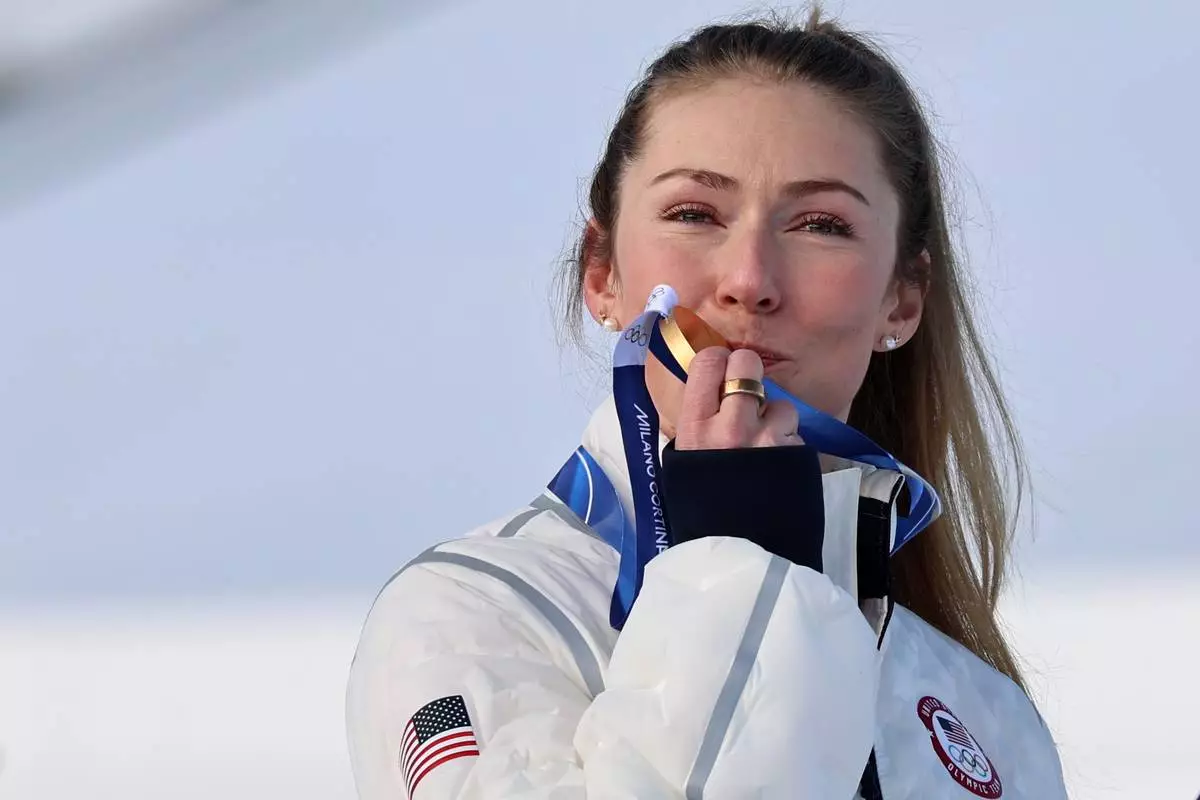 United States' Mikaela Shiffrin kisses the gold medal of the alpine ski, women's slalom race, at the 2026 Winter Olympics, in Cortina d'Ampezzo, Italy, Wednesday, Feb. 18, 2026. (AP Photo/Marco Trovati)