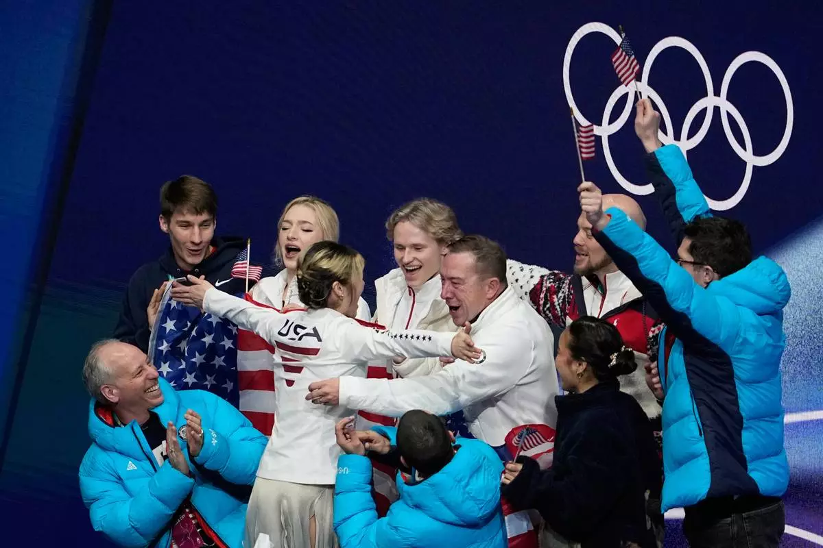 Alysa Lui of the United States reacts to her scores with her team after competing during the figure skating women's team event at the 2026 Winter Olympics, in Milan, Italy, Friday, Feb. 6, 2026. (AP Photo/Ashley Landis)