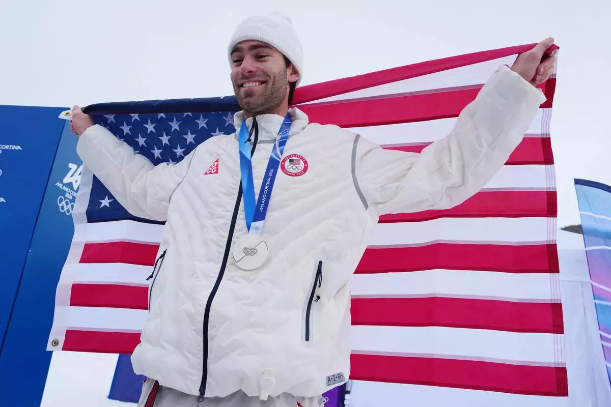 Silver medalist United States' Alex Hall holds an American flag after the men's freestyle skiing slopestyle finals at the 2026 Winter Olympics, in Livigno, Italy, Tuesday, Feb. 10, 2026. (AP Photo/Gregory Bull)