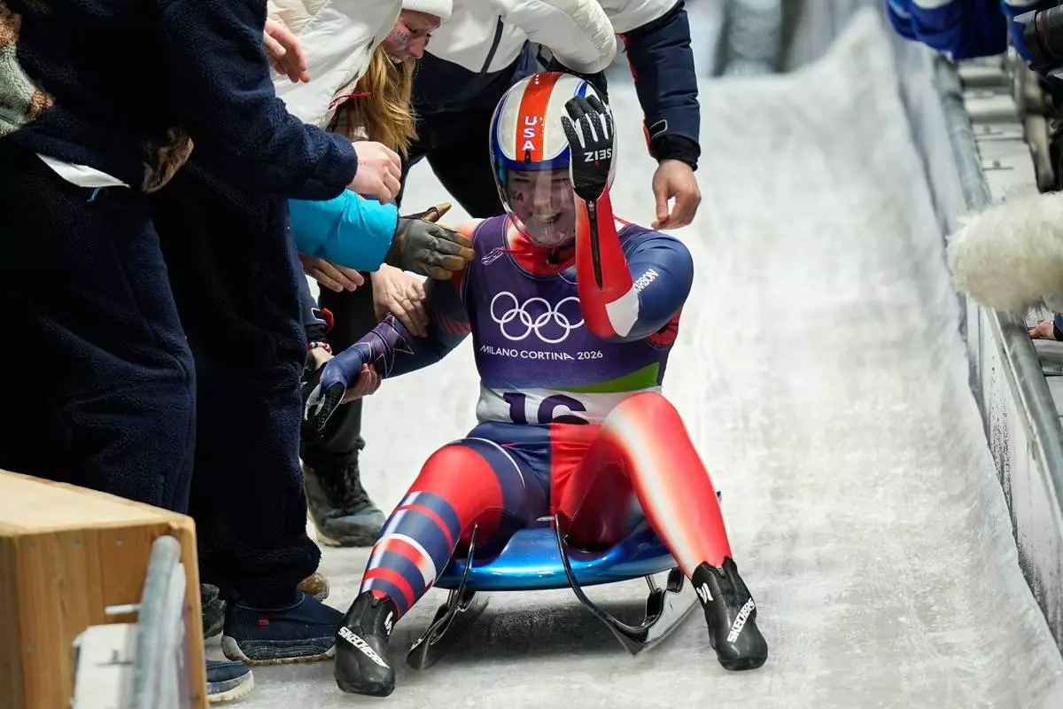 United States' Ashley Farquharson celebrates winning the bronze medal during a women's single luge competition at the 2026 Winter Olympics, in Cortina d'Ampezzo, Italy, Tuesday, Feb. 10, 2026. (AP Photo/Aijaz Rahi)