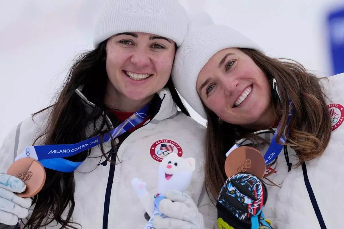 United States' Jacqueline Wiles, left, and teammate United States' Paula Moltzan show their bronze medals in an alpine ski, women's team combined race, at the 2026 Winter Olympics, in Cortina d'Ampezzo, Italy, Tuesday, Feb. 10, 2026. (AP Photo/Andy Wong)