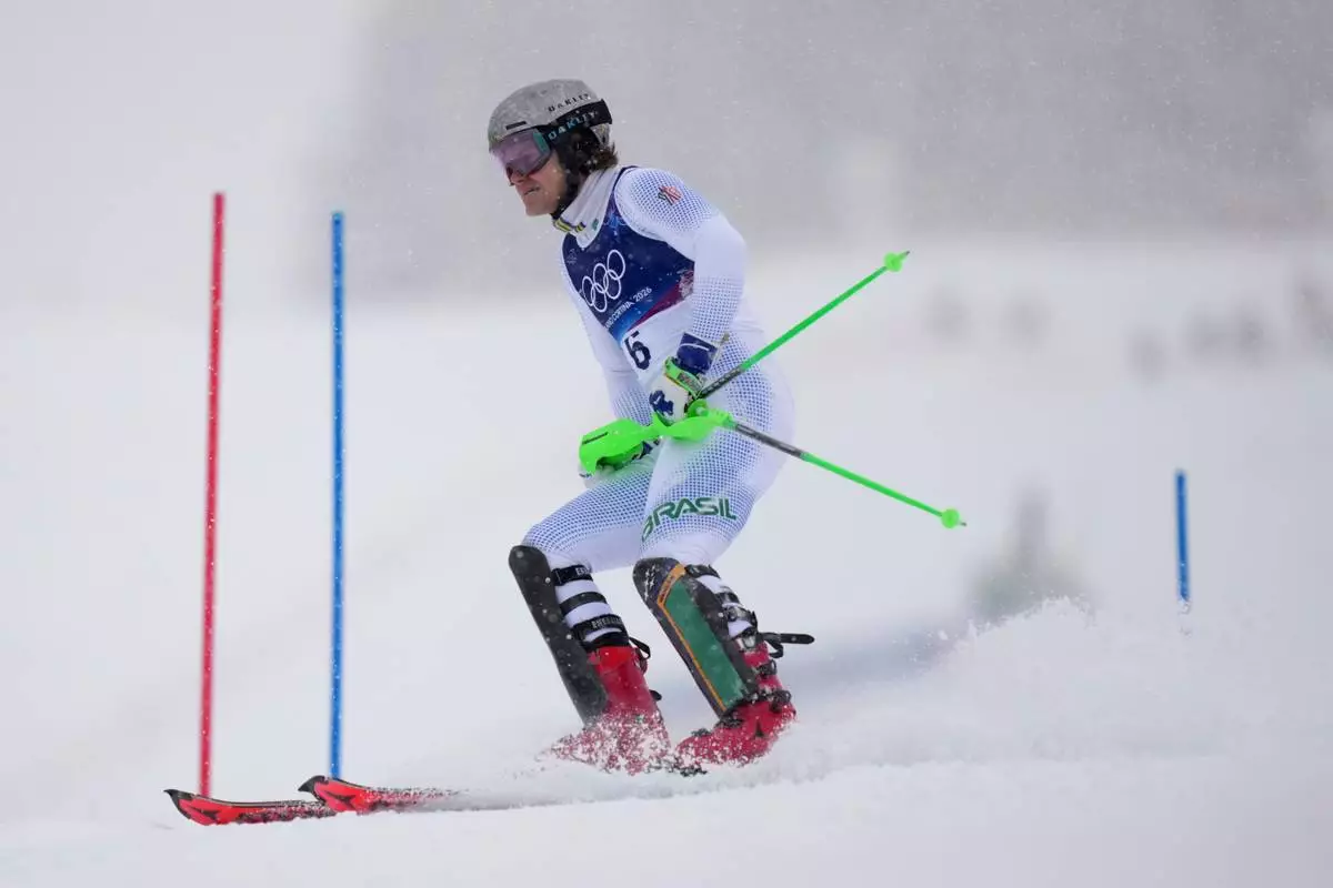 Brazil's Lucas Pinheiro Braathen skis down after crashing during an alpine ski, men's slalom race, at the 2026 Winter Olympics, in Bormio, Italy, Monday, Feb. 16, 2026. (AP Photo/Julia Demaree Nikhinson)