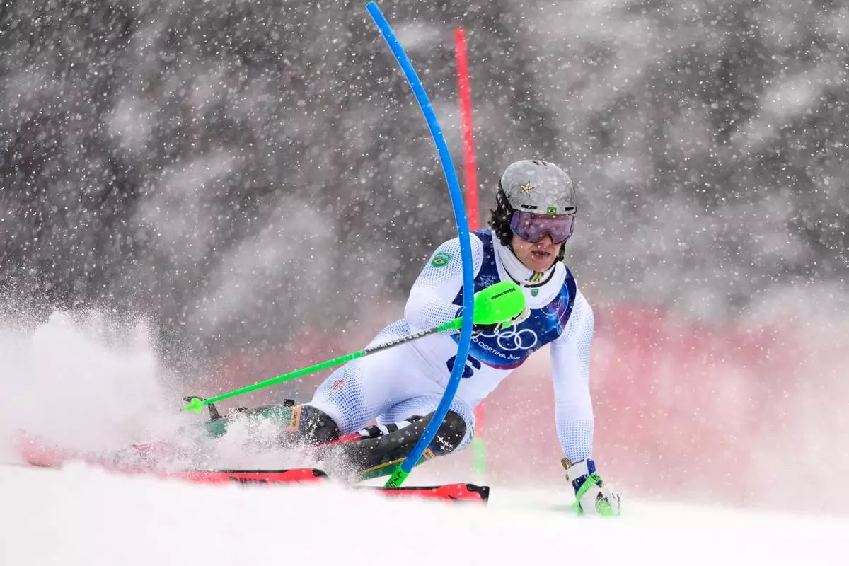 Brazil's Lucas Pinheiro Braathen speeds down the course, during an alpine ski, men's slalom race, at the 2026 Winter Olympics, in Bormio, Italy, Monday, Feb. 16, 2026. (AP Photo/John Locher)